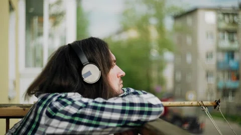 The guy lay down leaning on the edge of the balcony Stock Footage 228951070