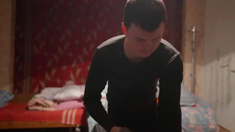 The guy lays out clothes before going to bed Stock Footage 231710832