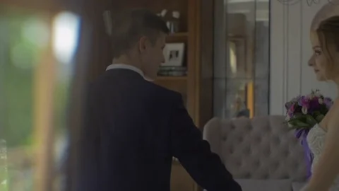 Guy leads the bride in the room by the hand to the balcony Stock-Footage 81397663