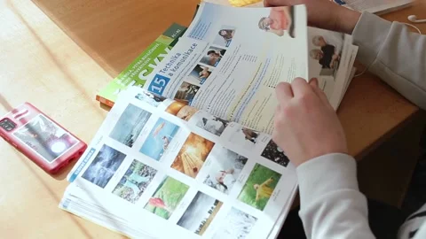The guy is leafing through a scientific journal, learning a new language. Video stock 149624296