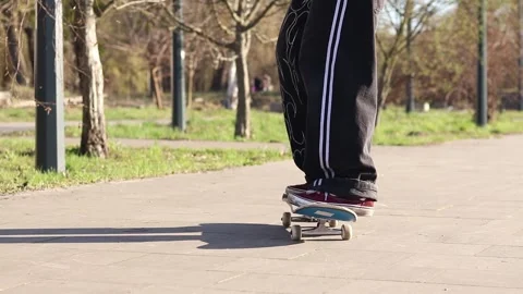 The guy is learning to do tricks on a skateboard 스톡 동영상 332353980