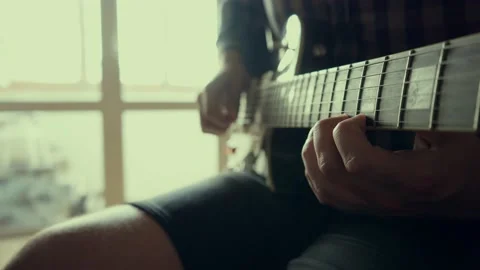 Guy learning to guitar at home Stock Footage 133908347