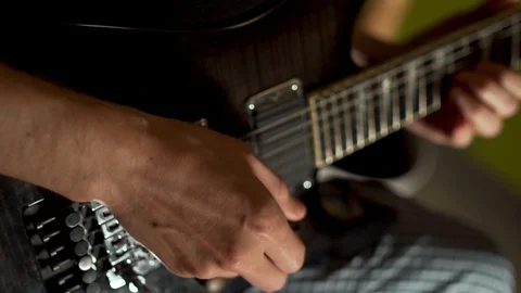 Guy learning to play electric guitar, close-up, slow motion Stock Footage 118956930