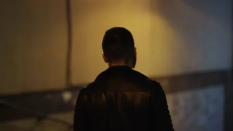 A guy in a leather jacket goes down to the underpass or subway Stock Footage 196241674