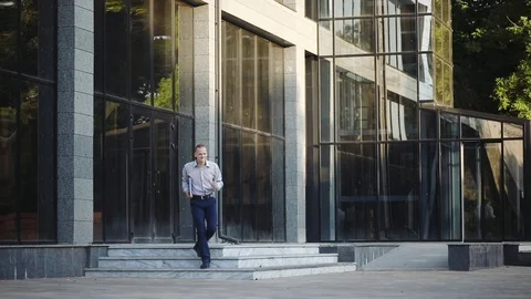 Guy leaves office building dancing happily in street Stock Footage 111278199