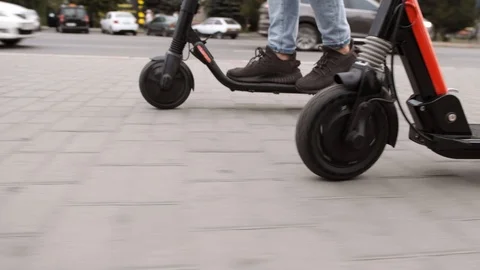 Guy legs ride future technology scooter low angle arc shot 스톡 동영상 119494659