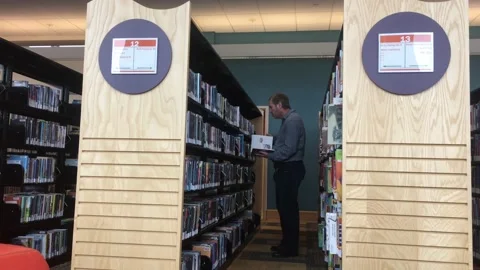 Guy in Library Looking for Books Video stock 98097289