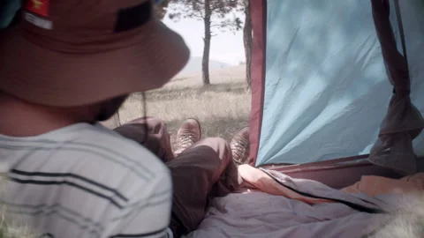 The guy lies in a tent resting Stock Footage 133815300