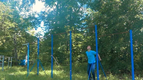 Guy lifts up on the horizontal bar Stock Footage 91326054