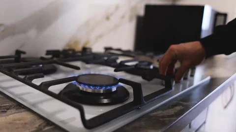 A guy is lighting a fire on a gas stove. Slow motion video Stock Footage 231814335