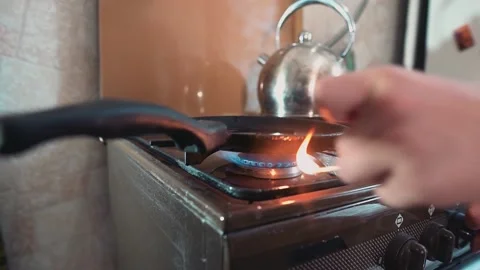 The guy lights the gas on the stove with a match. Close-up Stock Footage 134424350