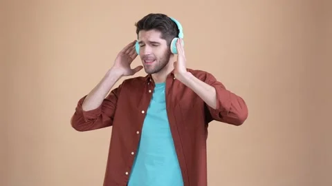 Guy listen headset single hit dance isolated pastel color background Stock Footage 169937522