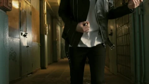 Guy with long hair simulates playing guitar at an underground location Stock Footage 287915382