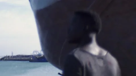 Guy looking around at the harbor 03 Stock Footage 67522052