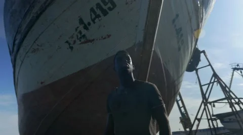 Guy looking around at the harbor 04 Stock Footage 67532405