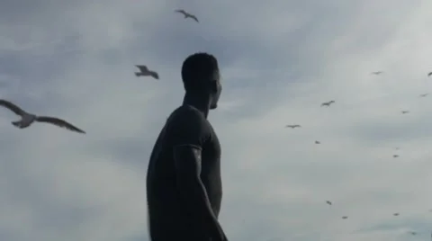 Guy looking at the birds in the sky 03 Video stock 67556149
