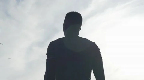 Guy looking at the birds in the sky Stock Footage 67556115