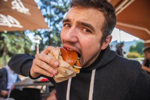 A guy is looking at the camera with the eyes full of dissapointment. He is ea Stock Photos