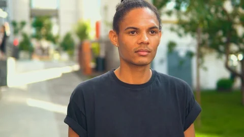 Guy looking at the camera standing on urban street Stock Footage 112968116