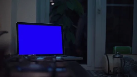 Guy looking at chroma key notebook computer screen at kitchen near stove Stock Footage 83253429