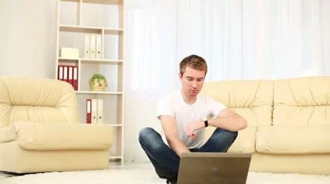 Guy looking at laptop. He raised his hands. DOLLY HD Stock Footage 8954514