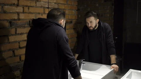 Guy is looking in the mirror Video stock 86257315