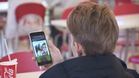 Guy is looking at the screen of a mobile phone. Skype. instagram story Vídeo Stock 113803505