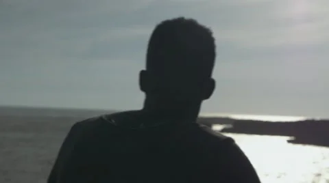 Guy looking at the seashore 02 Stock Footage 67556377