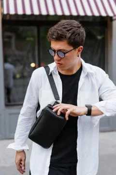 Guy looking for something in his bag. Stock Photos