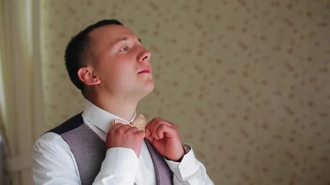 The guy looks ahead and adjusts his tie. A man is going to a meeting Stock Footage 144080854