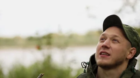 Guy looks up and adjusts the cap Video stock 93539532
