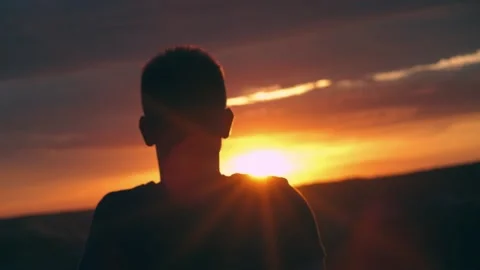 A guy looks at a beautiful sunset, Stock Footage 172089901