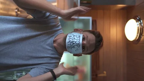 The guy looks at the camera at home in the kitchen Stock Footage 151534947