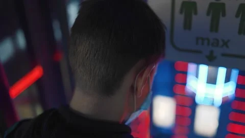 The guy looks down from a height in the direction of bright technological neon Stock Footage 154123839