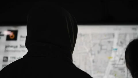 The guy looks at a large light map of the city hanging on the wall in the subway Stock Footage 154135984