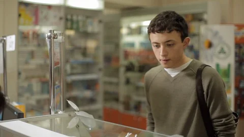 Guy looks at the medicines in the pharmacy window. Stock Footage 101607716