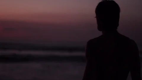 The guy looks at the ocean and then runs to swim Stock-Footage 82147477