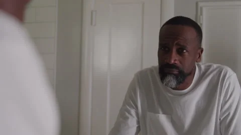 Guy Looks At Reflection In Mirror Stock Footage 208799362