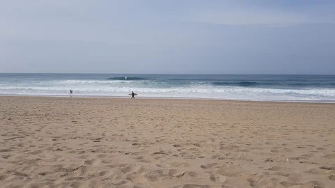 The guy looks like riding on the waves surfers 動画素材 103200691