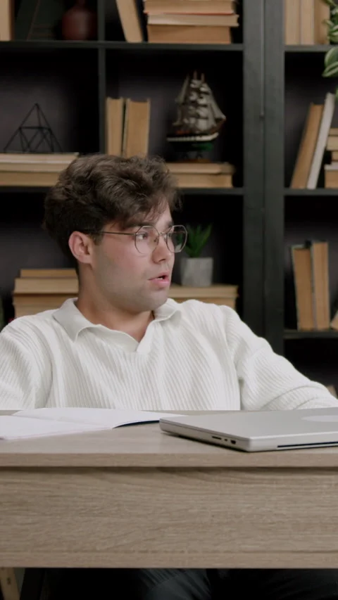Guy looks to side with closed laptop and silent presence Stock Footage 313928108