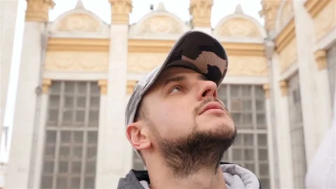 The guy looks at the tall columns. Slow motion. Close-up Stock Footage 103424852