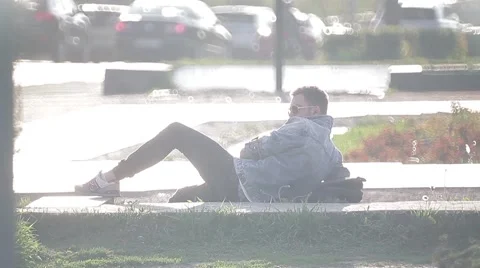 The guy is lying on the bench and waits Stock Footage 49700659