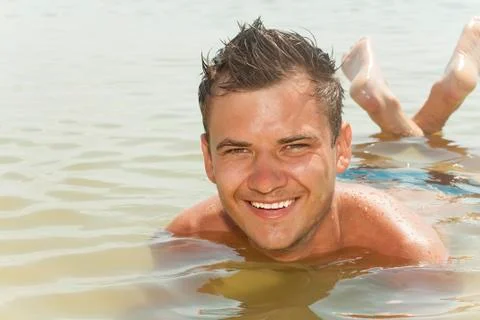 Guy lying in the water Stock Photos