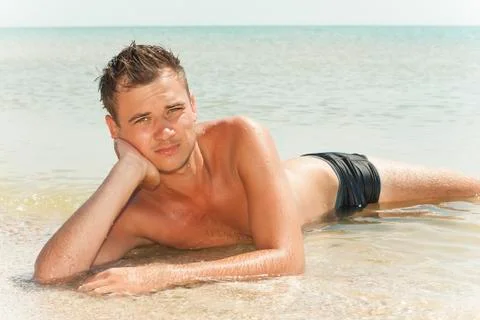Guy lying in the water Stock Photos