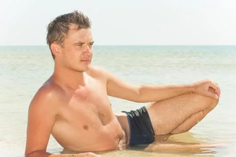 Guy lying in the water Stock Photos