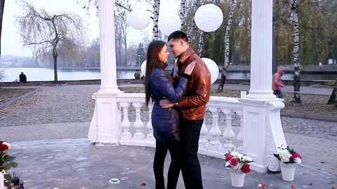 Guy make a surprise for your favorite girl in the park. Stock Footage 94590185