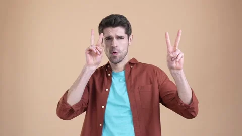 Guy make v-isgn hand isolated pastel color background Stock Footage 169937966