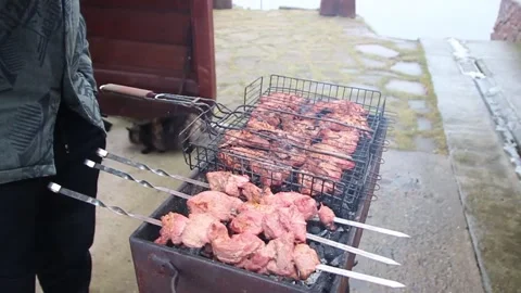 The guy makes a barbecue at home. Stock Footage 130741113