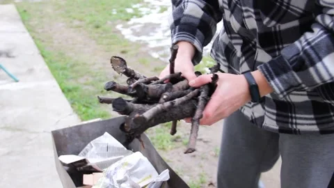 The guy makes a fire in the grill. Grilling food. Preparing for barbecue Stock Footage 146276342