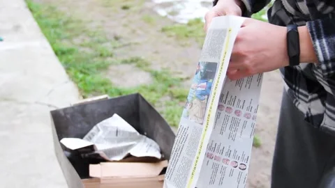 The guy makes a fire in the grill. Grilling food. Preparing for barbecue Stock Footage 146276632